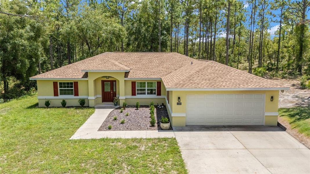 Front exterior of a new home in Rainbow Springs, Dunnellon, FL, highlighting curb appeal (Image 1).