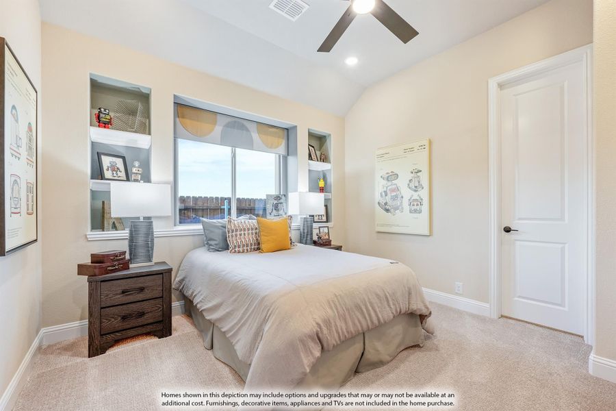 Secondary bedroom with built-in wall shelves, ceiling fan, and large window with carpet flooring Secondary bedroom with built-in wall shelves, ceiling fan, and large window with carpet flooring