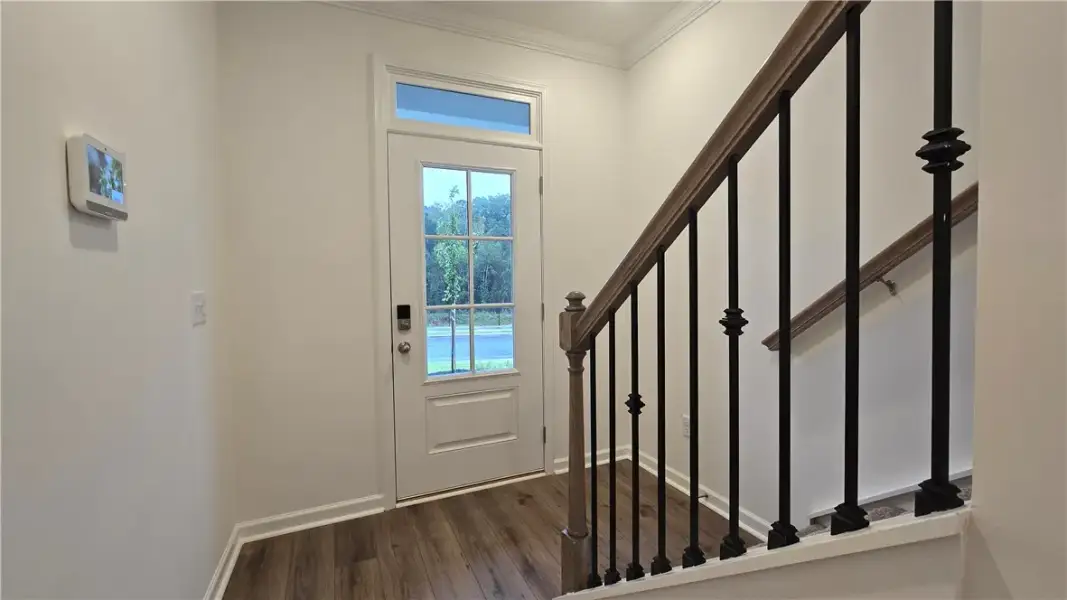 A welcoming entryway introduces rich wood flooring
