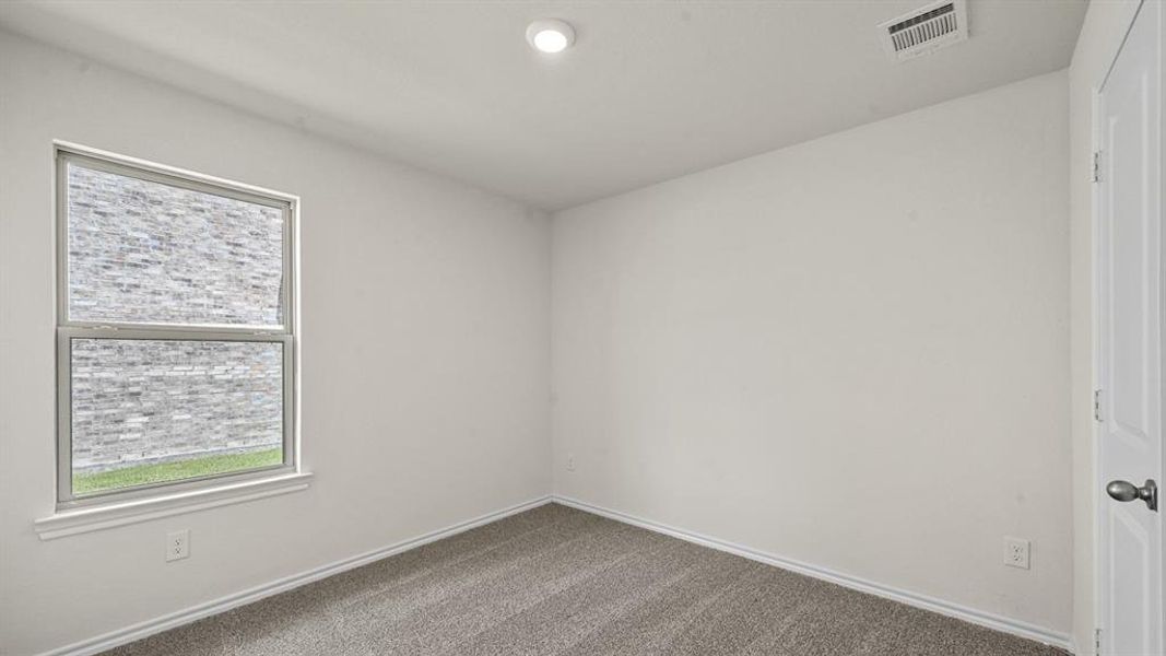Unfurnished room featuring carpet floors and baseboards