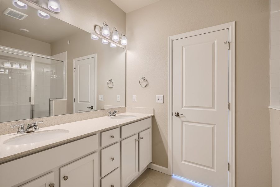 A bathroom with a large mirror.