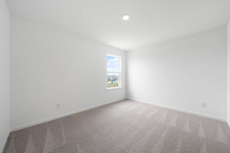 Spare room featuring light colored carpet and baseboards