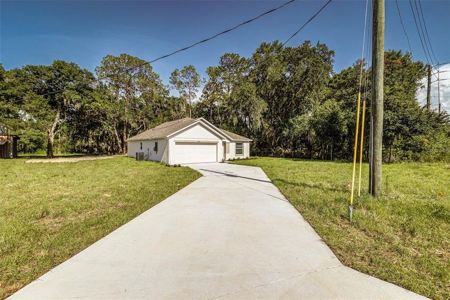 Front exterior of a new home in , Winter Haven, FL, highlighting curb appeal (Image 15).
