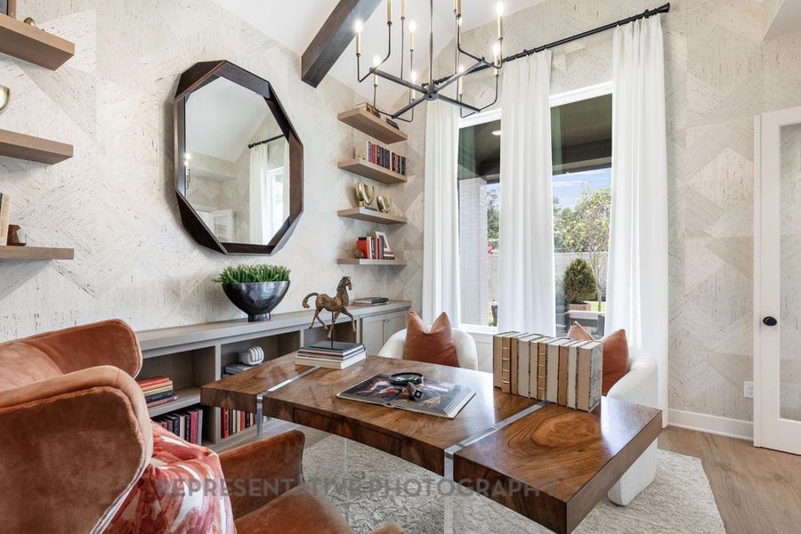 Living area with light wood-style floors and a chandelier Living area with light wood-style floors and a chandelier