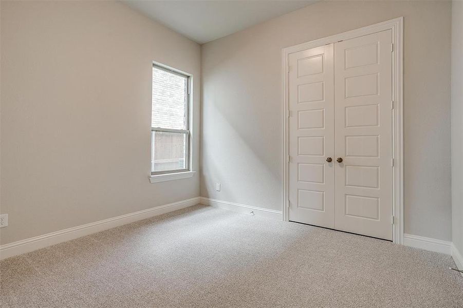 Unfurnished bedroom featuring a closet and carpet floors