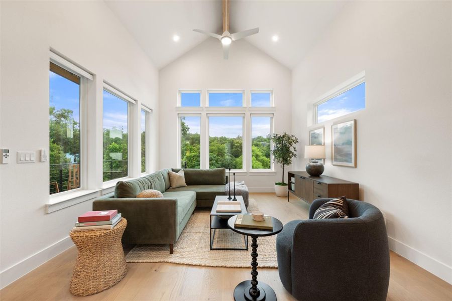 Vast windows illuminate this living space, offering tranquil views and an inviting atmosphere. Vast windows illuminate this living space, offering tranquil views and an inviting atmosphere.