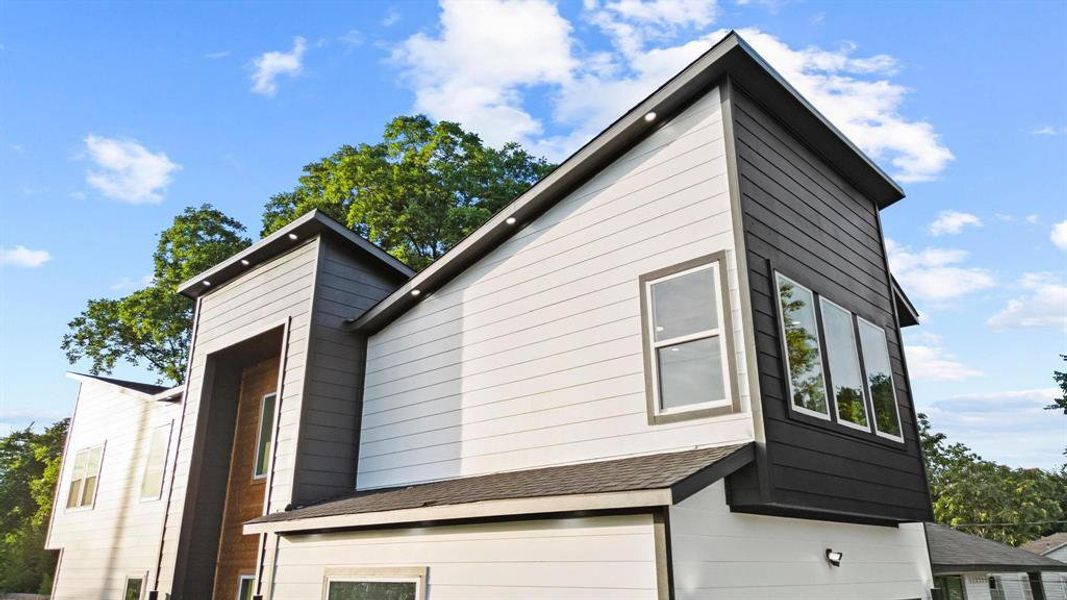 View of home's exterior with a shingled roof