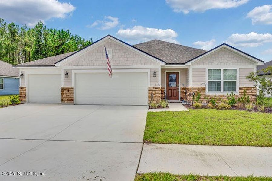 Front exterior of a new home in Edinburgh Village, Jacksonville, FL, highlighting curb appeal (Image 21). Front exterior of a new home in Edinburgh Village, Jacksonville, FL, highlighting curb appeal (Image 21).