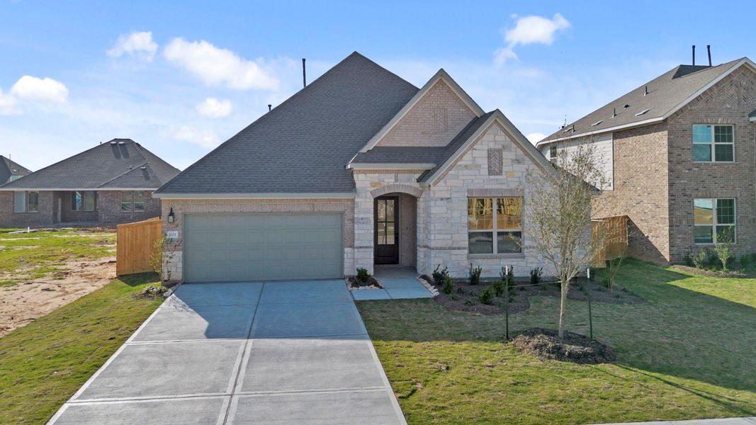Front exterior of a new home in Sunterra Lakes, Brookshire, TX, highlighting curb appeal (Image 23).