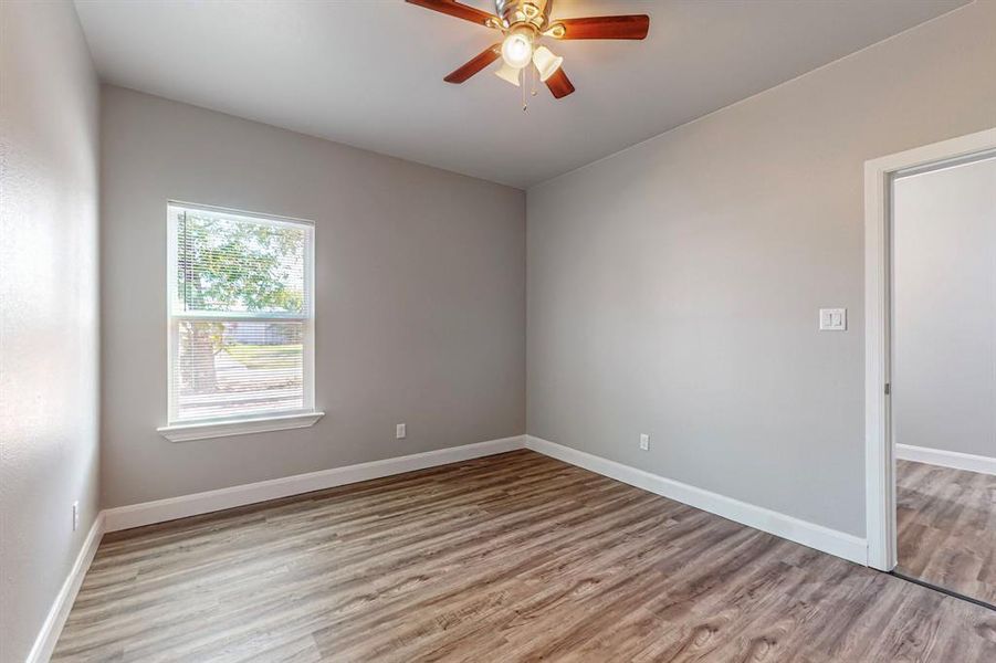 Spare room featuring ceiling fan and light hardwood / wood-style floors