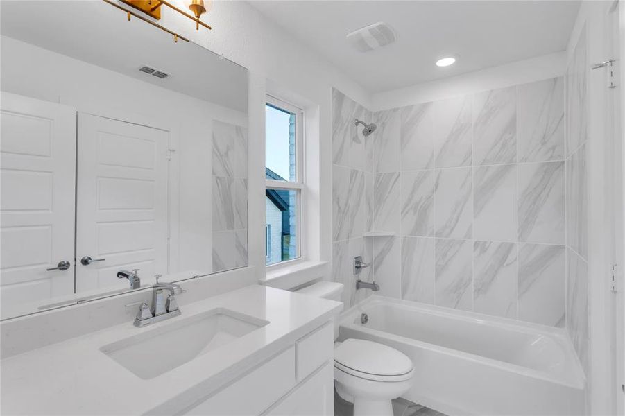 Bathroom with shower / bathtub combination and vanity