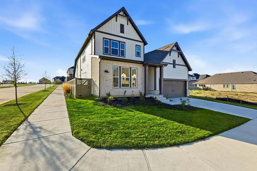 Front exterior of a new home in Pecan Square - Gardens, Northlake, TX, highlighting curb appeal (Image 2). Front exterior of a new home in Pecan Square - Gardens, Northlake, TX, highlighting curb appeal (Image 2).