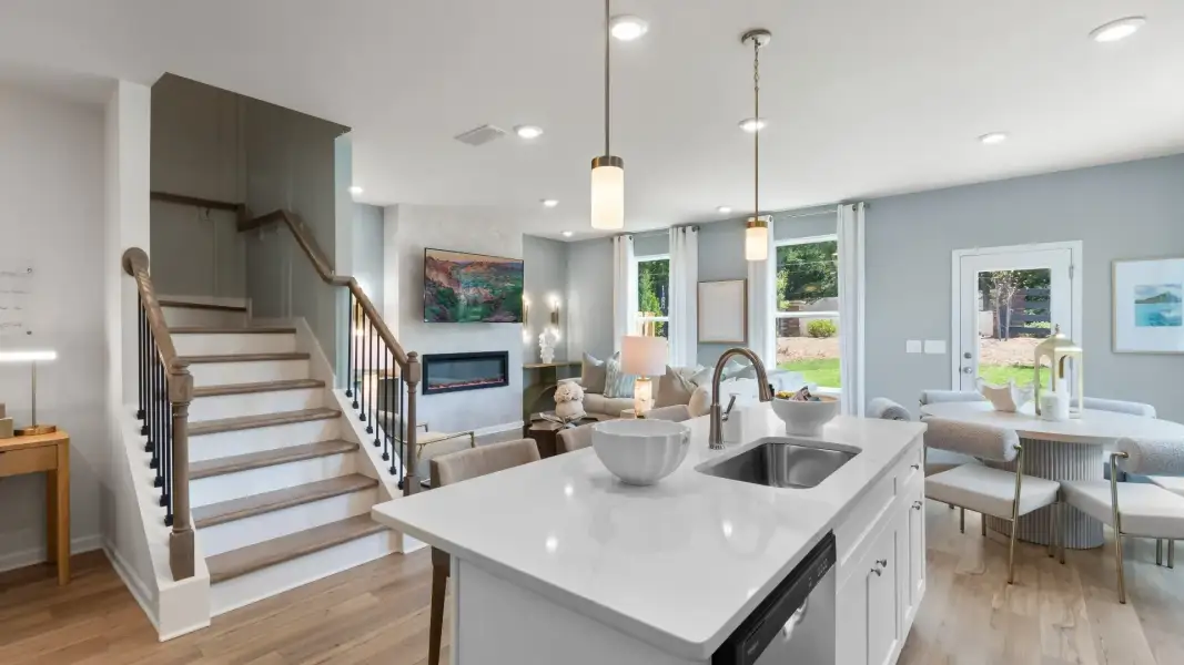 Open concept kitchen and family room in new construction townhome with seamless flow and natural light. Open concept kitchen and family room in new construction townhome with seamless flow and natural light.