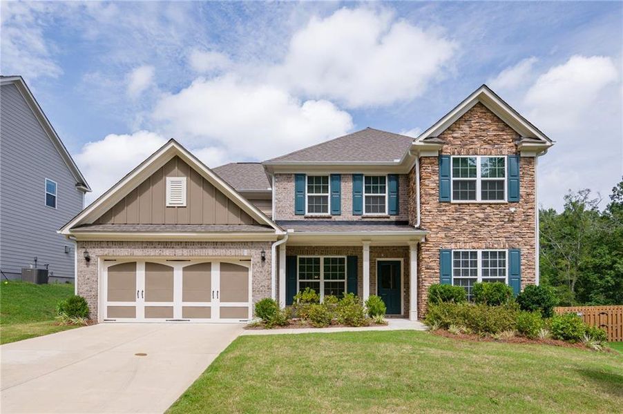 Front exterior of a new home in Sierra Creek, Hoschton, GA, highlighting curb appeal (Image 2). Front exterior of a new home in Sierra Creek, Hoschton, GA, highlighting curb appeal (Image 2).