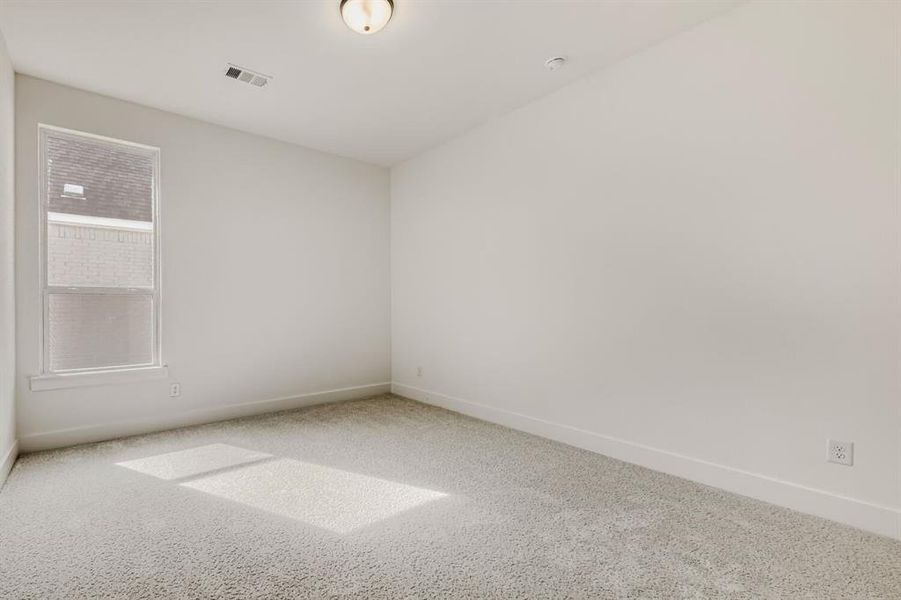 Empty room with carpet and baseboards