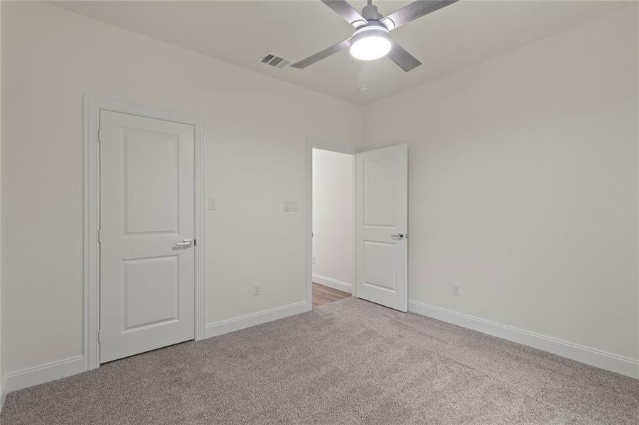 Room featuring light gray carpeting and white trim Room featuring light gray carpeting and white trim