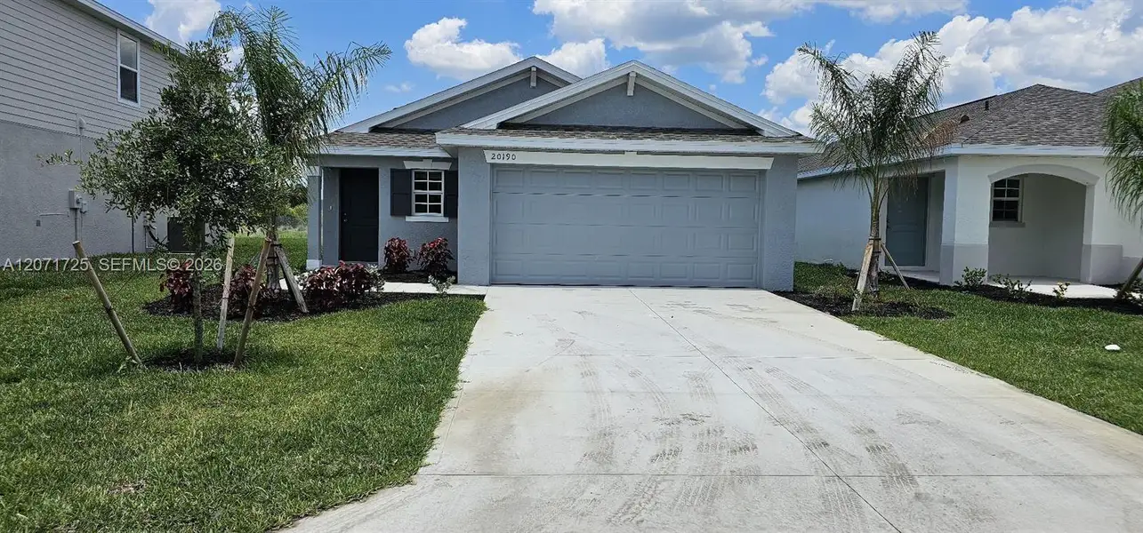 Front exterior of a new home in , Lehigh Acres, FL, highlighting curb appeal (Image 2). Front exterior of a new home in , Lehigh Acres, FL, highlighting curb appeal (Image 2).