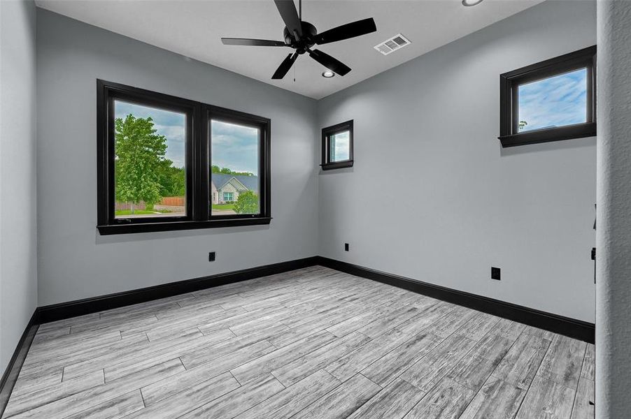 Spare room with a ceiling fan, light wood-type flooring, baseboards, and recessed lighting Spare room with a ceiling fan, light wood-type flooring, baseboards, and recessed lighting