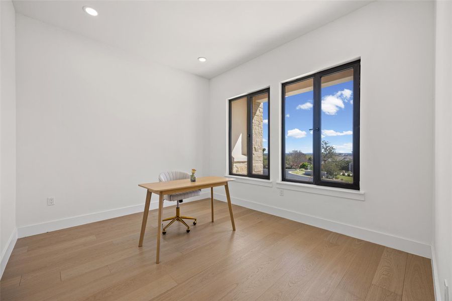 Unfurnished office featuring light wood-style floors and recessed lighting