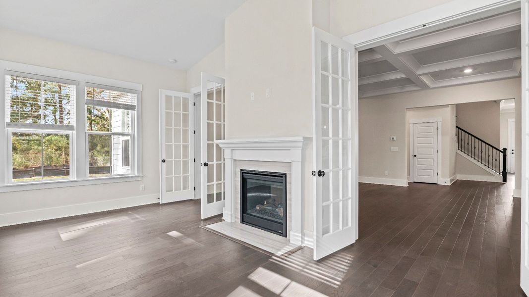 morning room with double sided fireplace Stonehaven II by DRB Homes