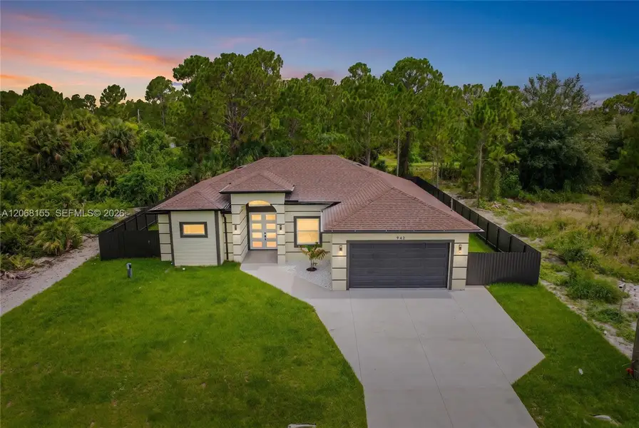 Front exterior of a new home in , Lehigh Acres, FL, highlighting curb appeal (Image 24). Front exterior of a new home in , Lehigh Acres, FL, highlighting curb appeal (Image 24).