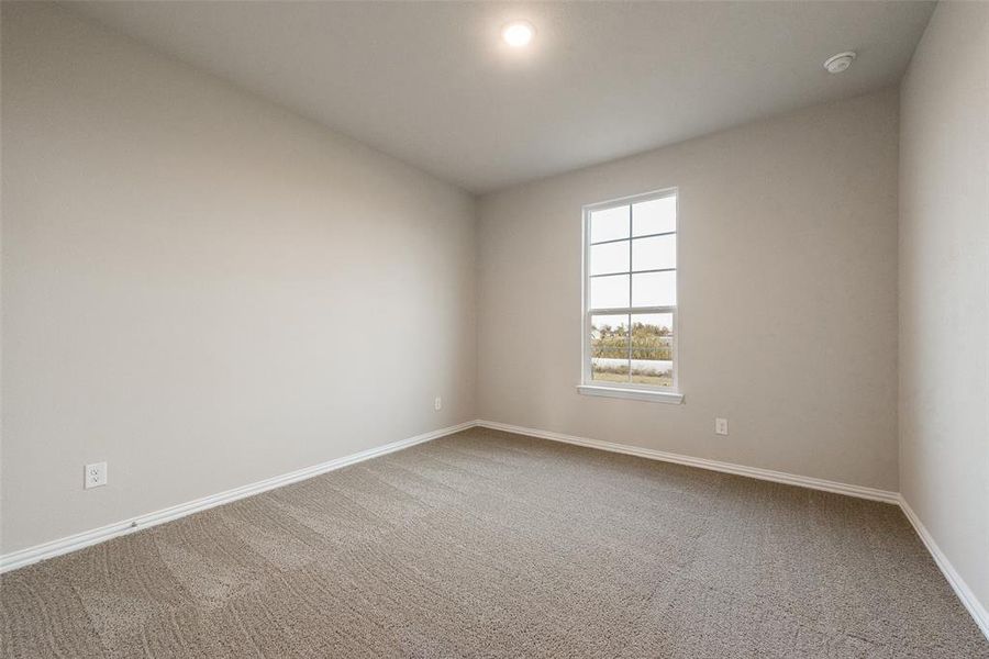 Unfurnished room with light colored carpet and baseboards