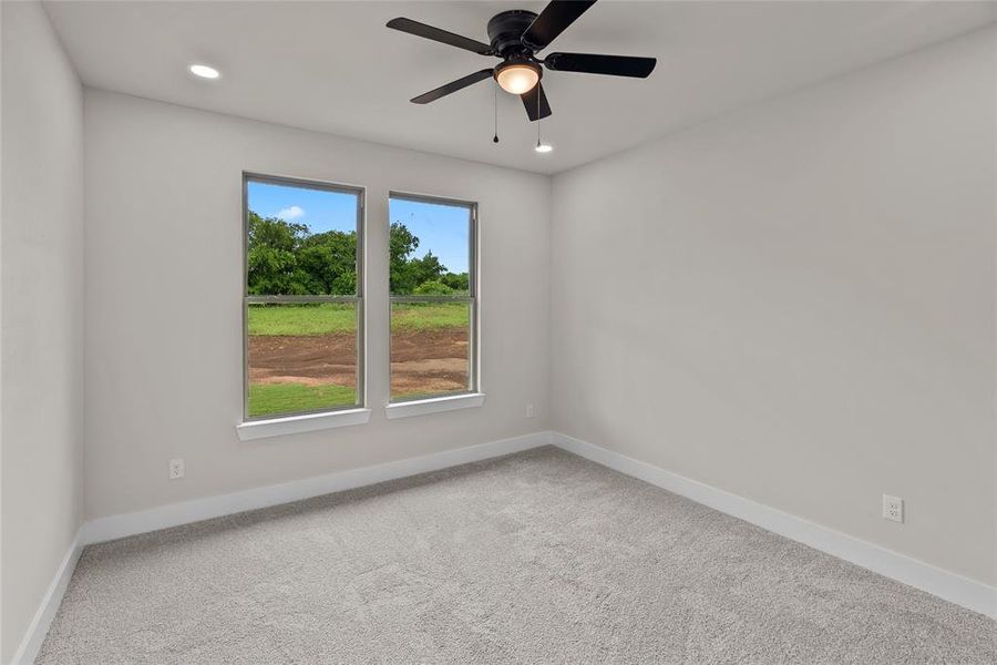Spare room featuring baseboards, carpet flooring, a ceiling fan, and recessed lighting
