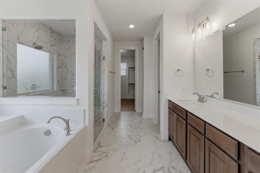 Dual vanity with integrated sinks, brushed nickel fixtures, and white countertops Dual vanity with integrated sinks, brushed nickel fixtures, and white countertops
