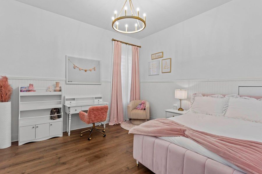 Bedroom featuring dark hardwood / wood-style flooring and a notable chandelier