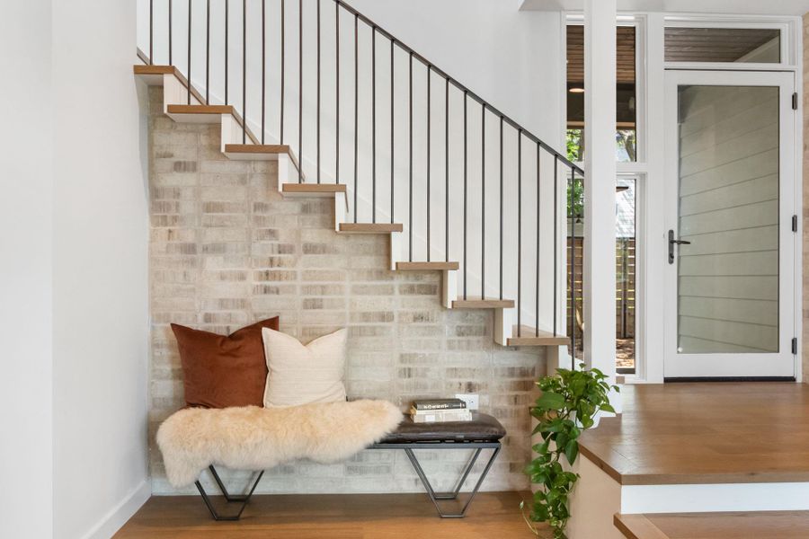 Stairway featuring wood finished floors