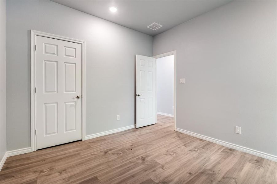 Unfurnished bedroom with light hardwood / wood-style floors