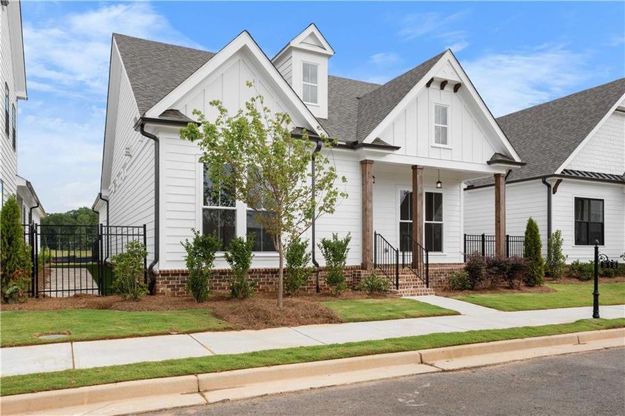 Front exterior of a new home in Promenade at Sawnee Village, Cumming, GA, highlighting curb appeal (Image 2). Front exterior of a new home in Promenade at Sawnee Village, Cumming, GA, highlighting curb appeal (Image 2).