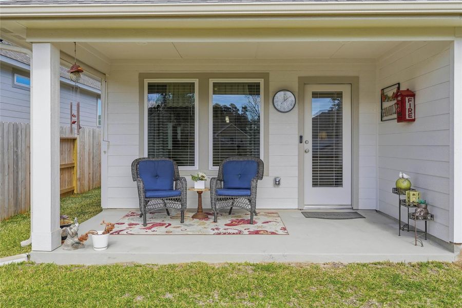 The covered back patio provides a relaxing outdoor space to sit and enjoy your morning coffee.