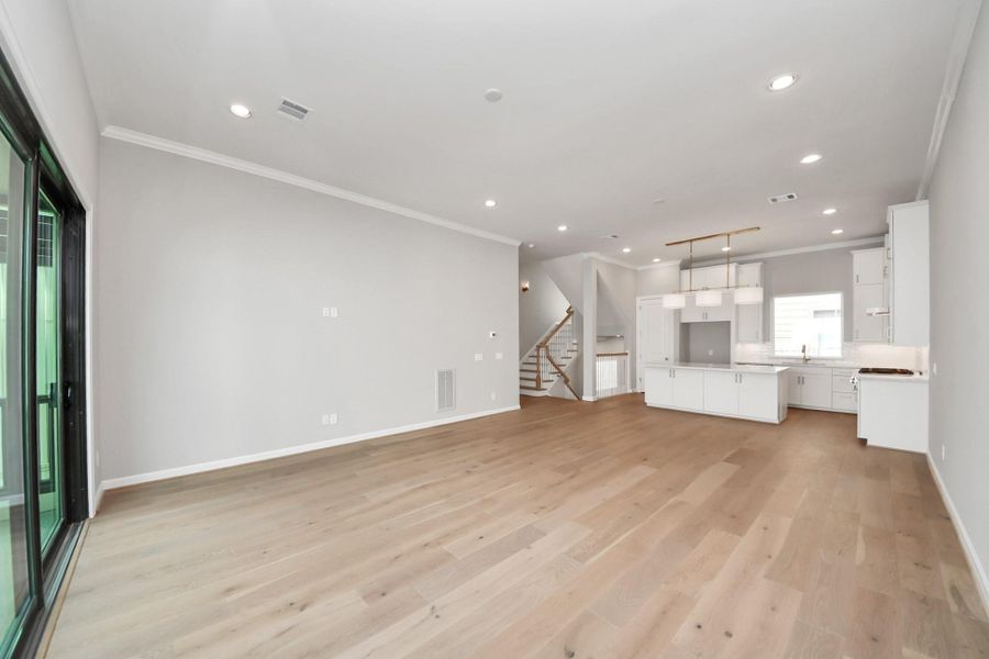 Light-filled living and dining areas featuring engineered wood flooring and an open-concept design. Light-filled living and dining areas featuring engineered wood flooring and an open-concept design.