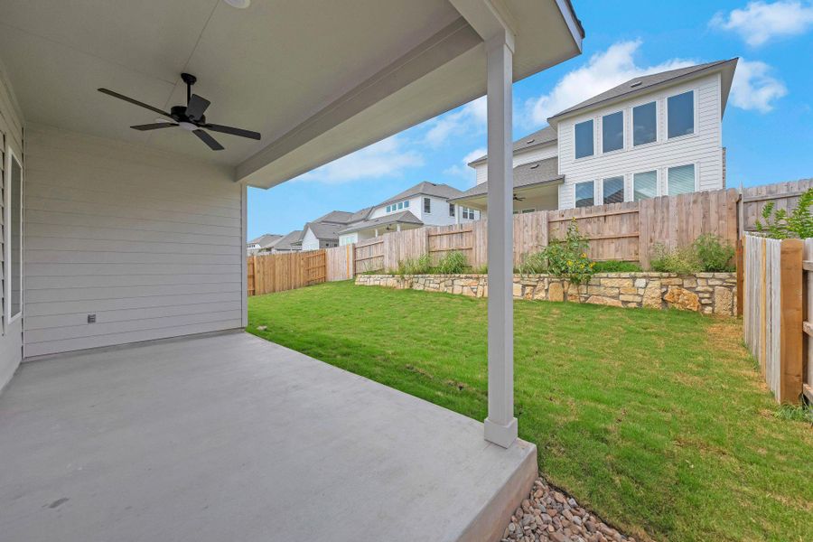 Fenced backyard featuring ceiling fan, a patio area, and a residential view Fenced backyard featuring ceiling fan, a patio area, and a residential view