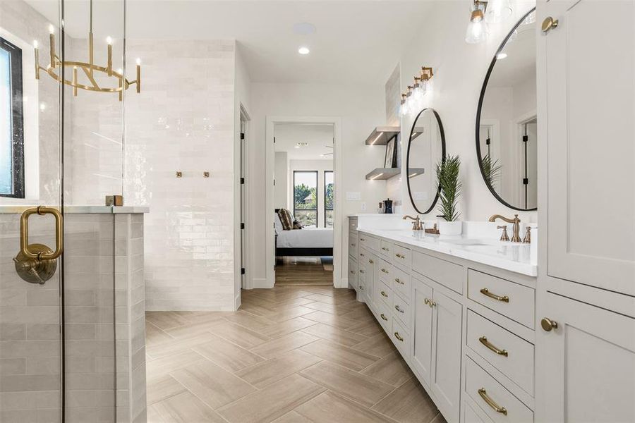 Ensuite bathroom featuring double vanity, a stall shower, recessed lighting, and a chandelier Ensuite bathroom featuring double vanity, a stall shower, recessed lighting, and a chandelier