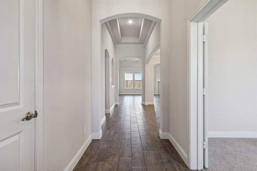 The Foyer Hallway Features dark hardwood/wood-style floors & gorgeous raised ceiling. Notice the convenient coat closet on the left...