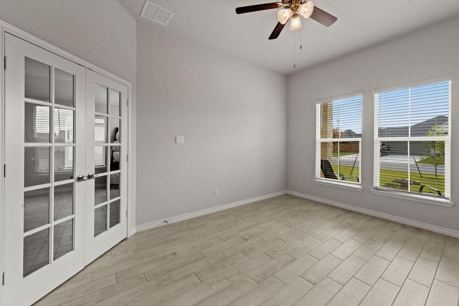 Unfurnished room with french doors, light wood-type flooring, and a ceiling fan