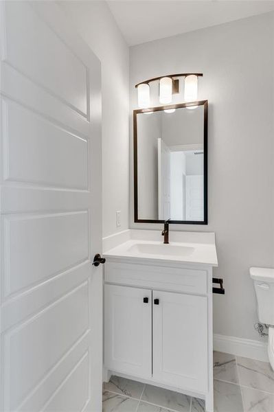 Bathroom featuring vanity and toilet