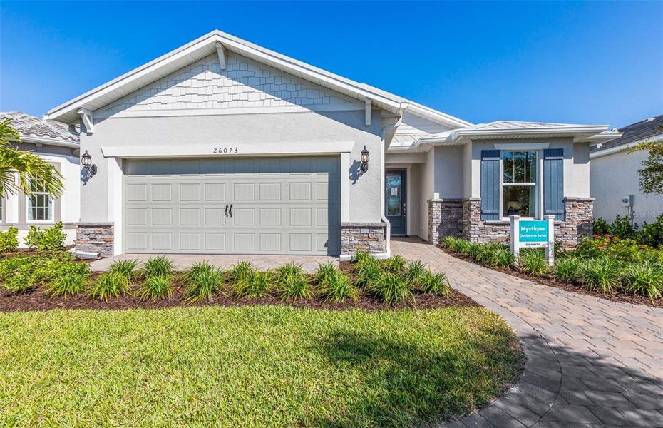 Front exterior of a new home in BeachWalk by Manasota Key, Englewood, FL, highlighting curb appeal (Image 2). Front exterior of a new home in BeachWalk by Manasota Key, Englewood, FL, highlighting curb appeal (Image 2).