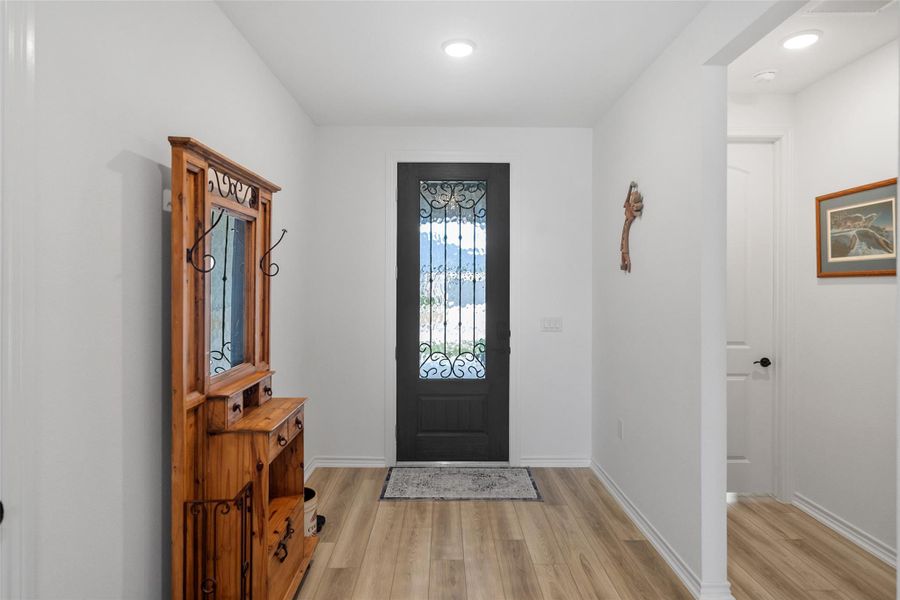 Wide entry hallway is clean and bright and shows the hallway entrance to one of the 2 extra bedrooms. This home is like-new - you don't have to wait on new construction!