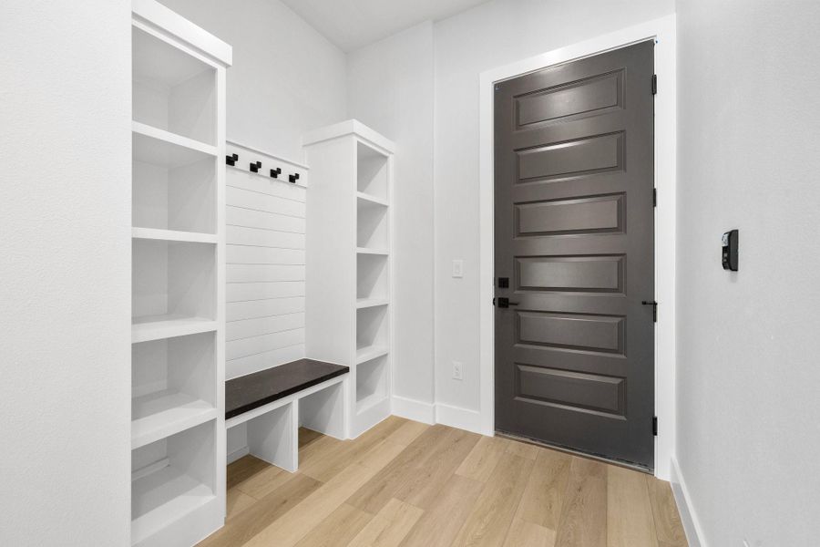 Cubbies and hooks near the door to the garage. Cubbies and hooks near the door to the garage.