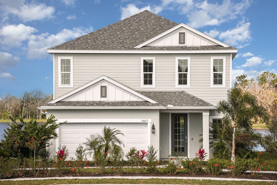 Front exterior of a new home in Wildleaf, Parrish, FL, highlighting curb appeal (Image 26).