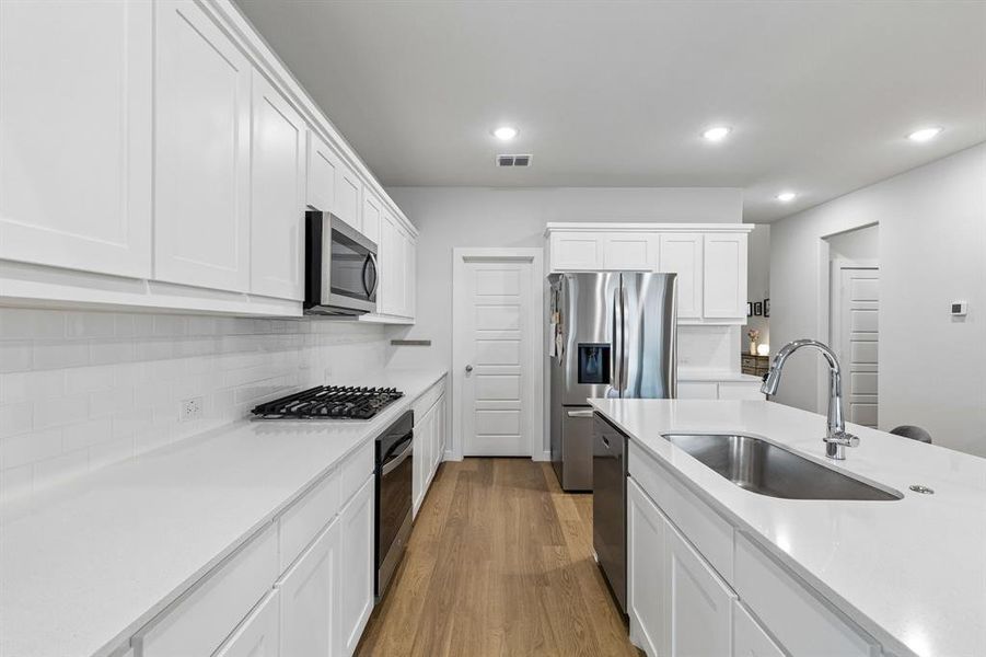 White cabinets, quartz countertops, gas cooktop, stainless steel appliances White cabinets, quartz countertops, gas cooktop, stainless steel appliances
