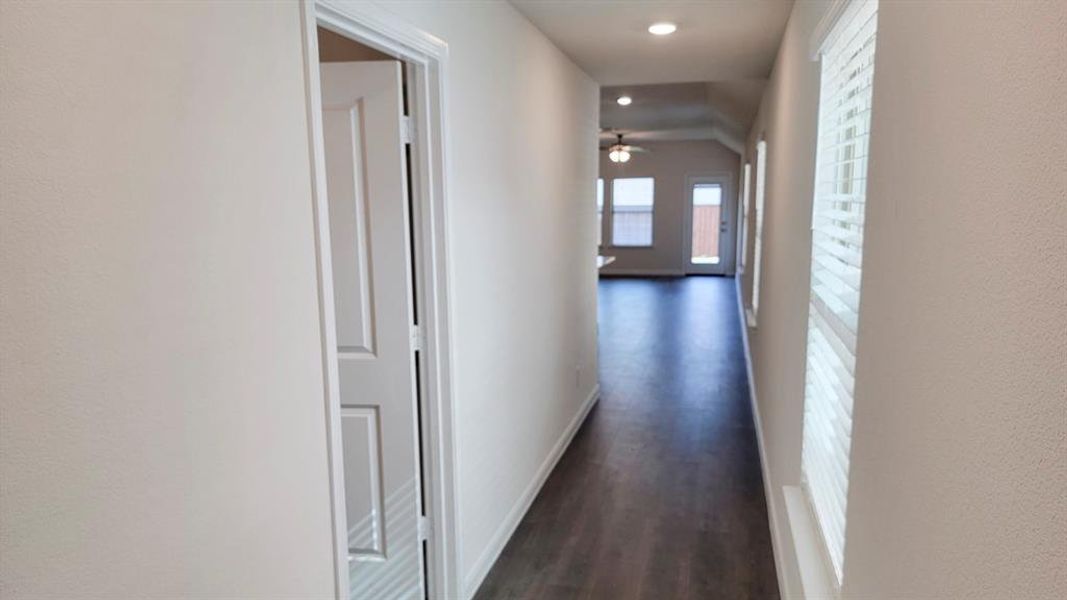 Hall with dark wood-style flooring and recessed lighting Hall with dark wood-style flooring and recessed lighting