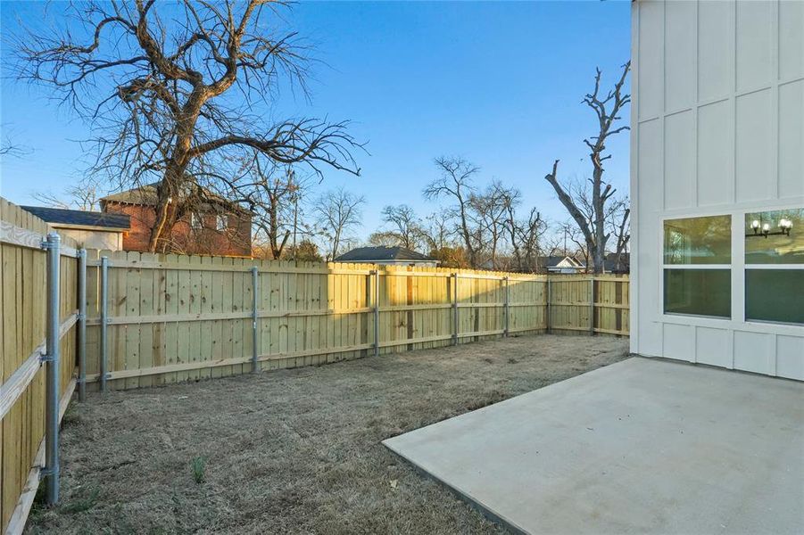 Fenced backyard with a patio area
