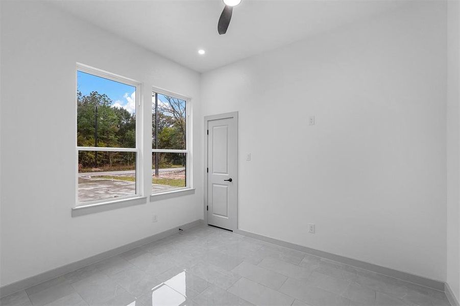 Spare room with ceiling fan