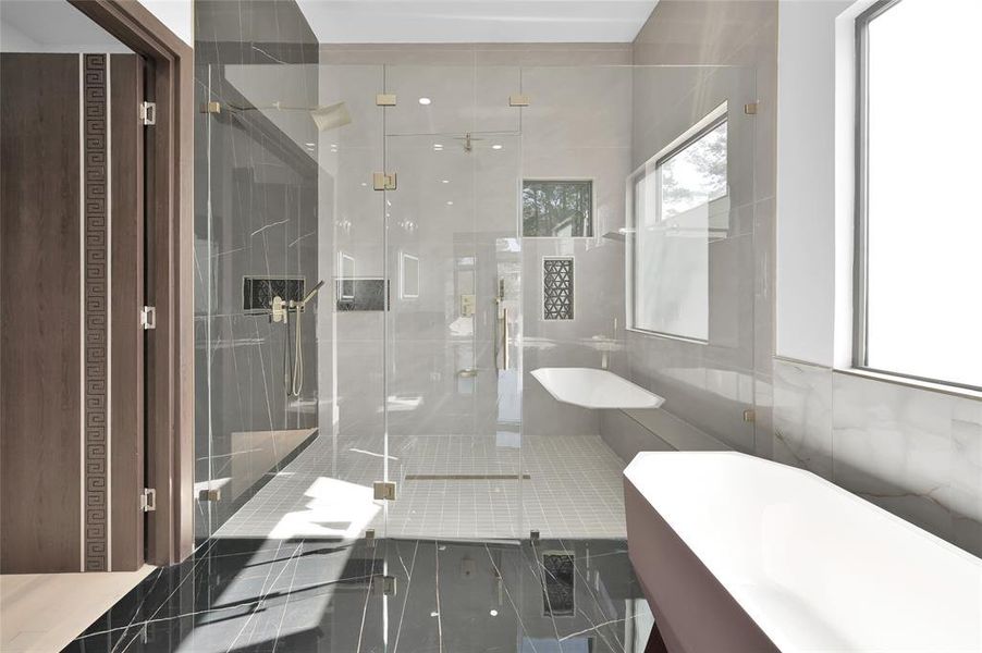 Luxurious 9'x6' shower featuring three shower heads and two handhelds for a spa-like experience.