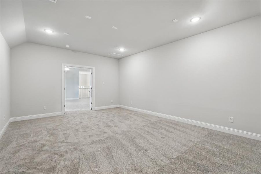 Unfurnished room with baseboards, light carpet, recessed lighting, and vaulted ceiling