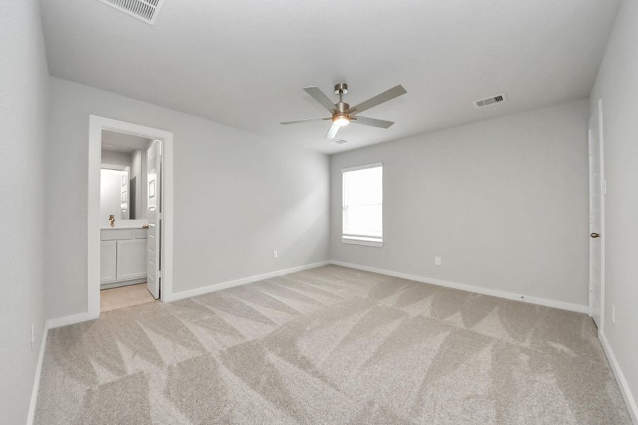Secondary bedroom features plush carpeting, large windows that let in plenty of natural light, bright paint, and spacious closets.